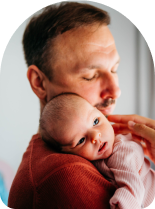 young man holding new baby