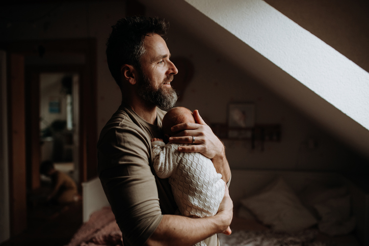 Father holding his newborn baby. Unconditional paternal love and Father's Day concept.