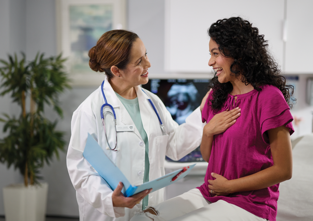 Smiling doctor with female patient