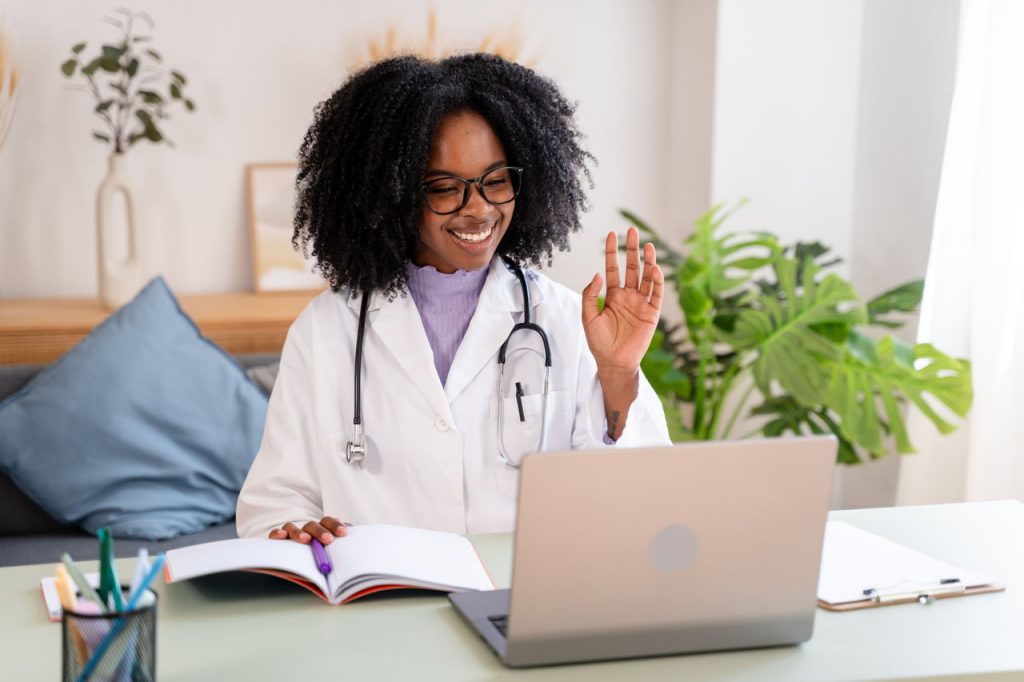 Smiling doctor with female patient