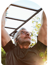 Man excercises on monkey bars in the inland empire.