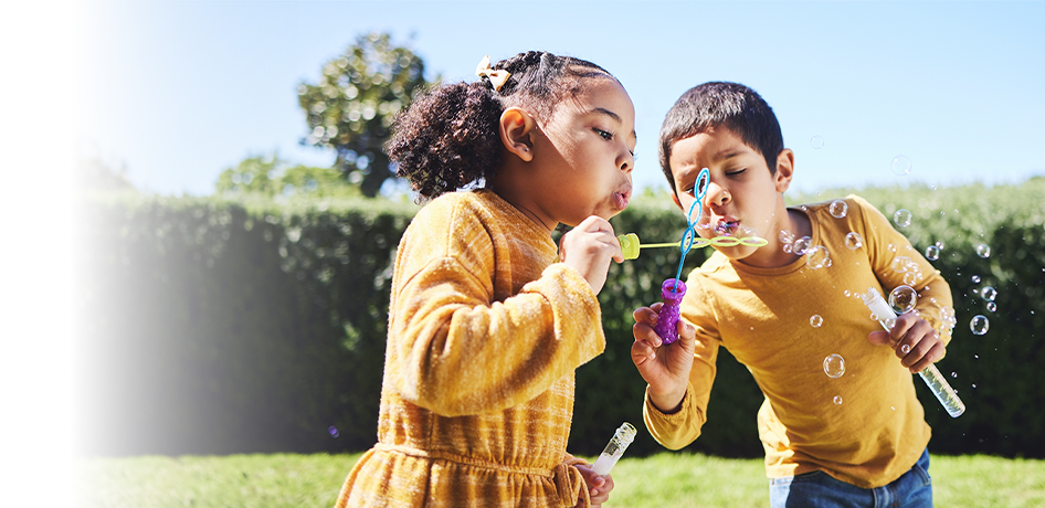 Kids playing outside with bubbles