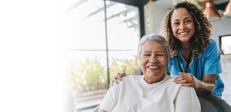 Black woman doctor smiling with older hispanic patient