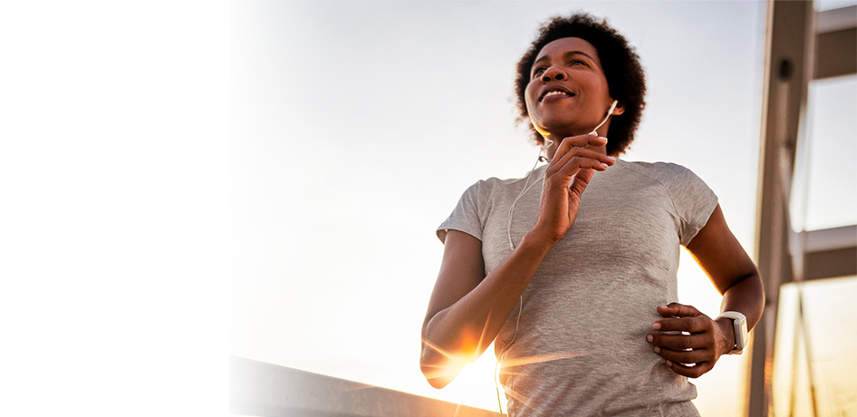Black woman running on a bridge