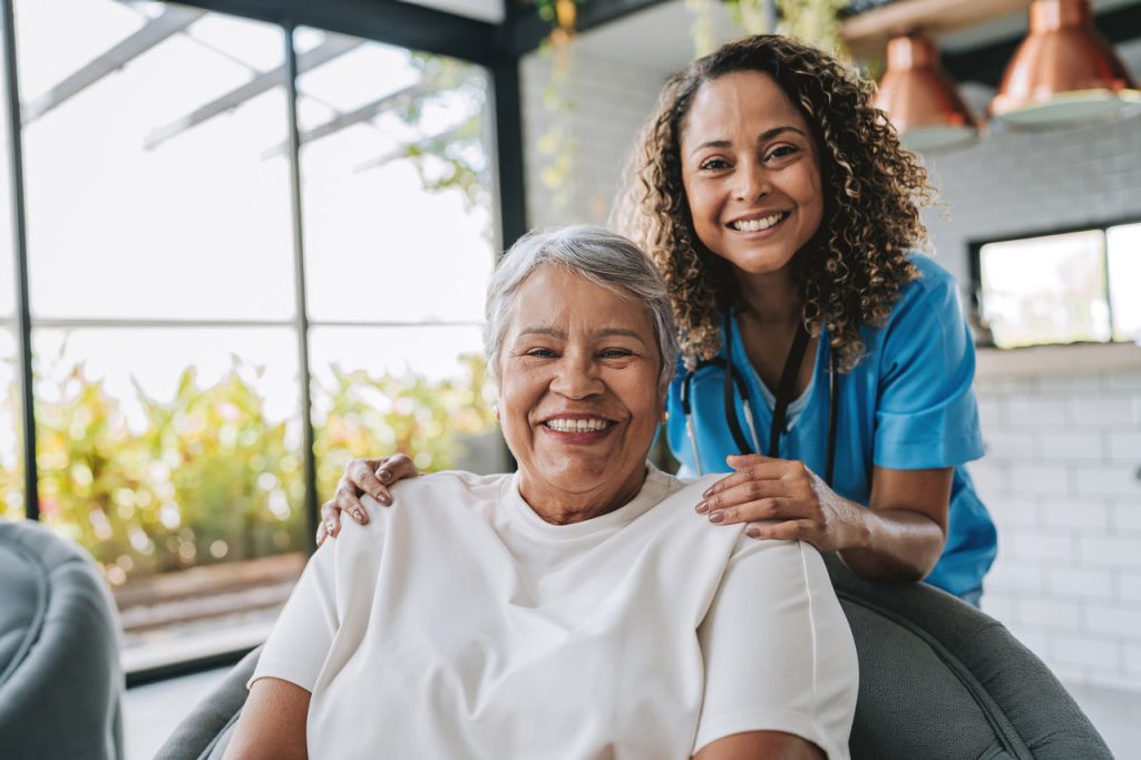 Home care healthcare professional hugging elderly patient