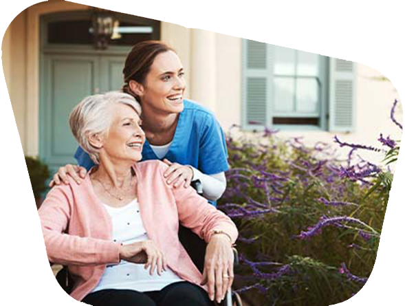 health professional with patient smiling outside