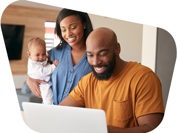 Happy family looking at the laptop together 
