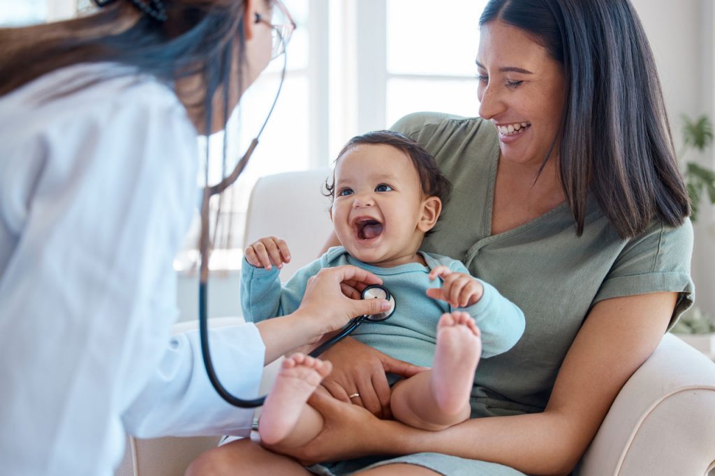 Smiling doctor with child patient