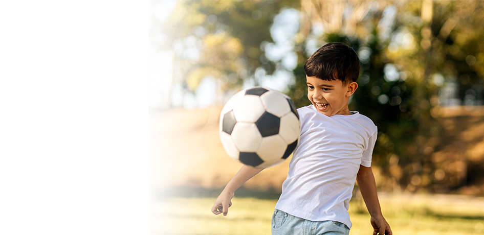 Young boy playing soccer