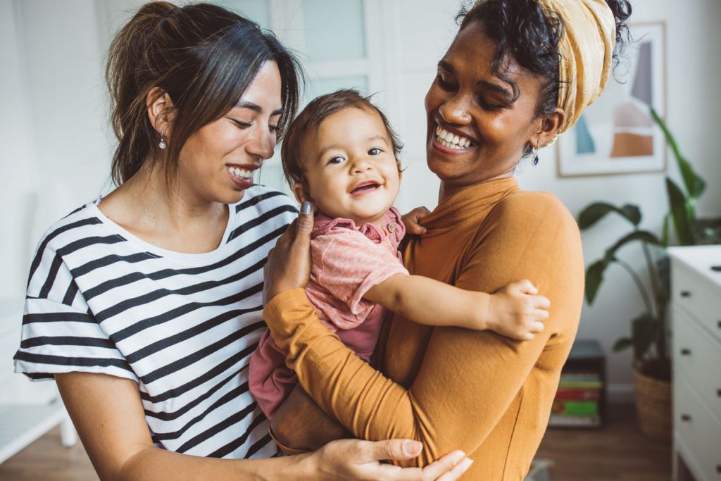LGBTQ family holding baby